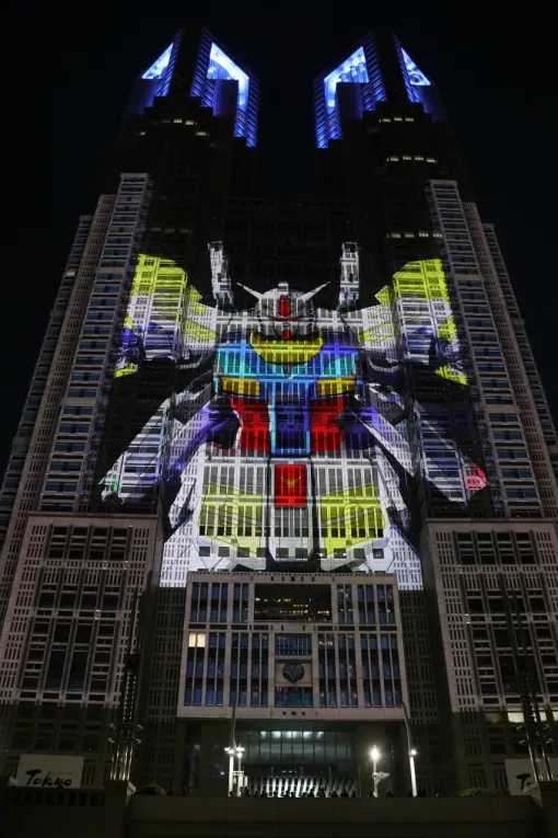 東京都庁の壁面をガンダムが縦横無尽に飛び回る。プロジェクションマッピング「TOKYO Night & Light」にて，「TOKYO GUNDAM IN THE FUTURE」上映中